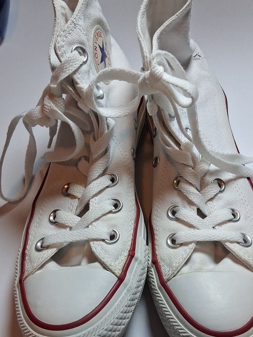 Converse white high-top sneakers with red trim